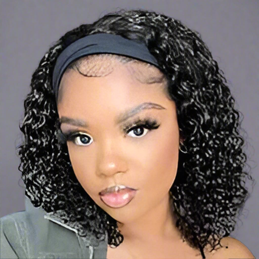 Woman wearing a black headband with curly hair, against a neutral background